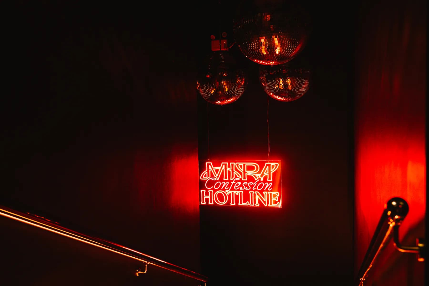 MIRA neon sign and mirror balls at the club