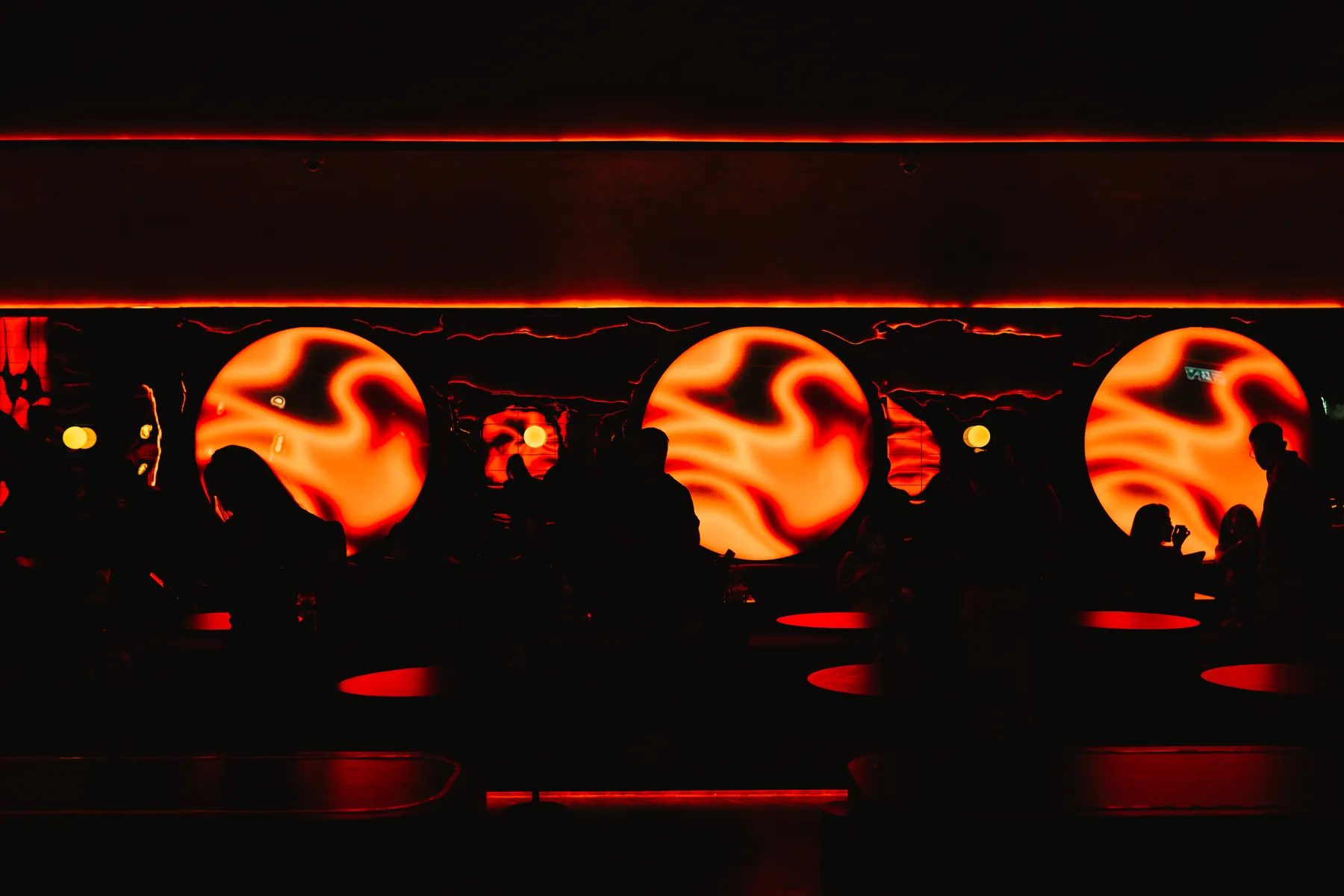 The main room at MIRA in warm red light