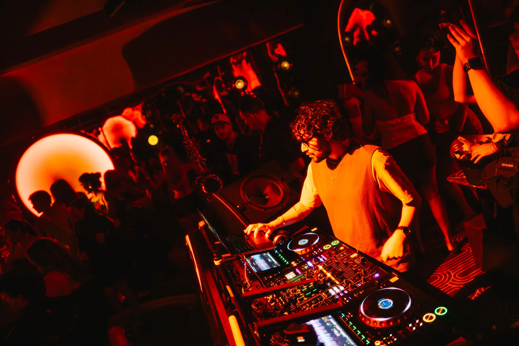 A resident DJ at the booth at MIRA on Sukhumvit Soi 11