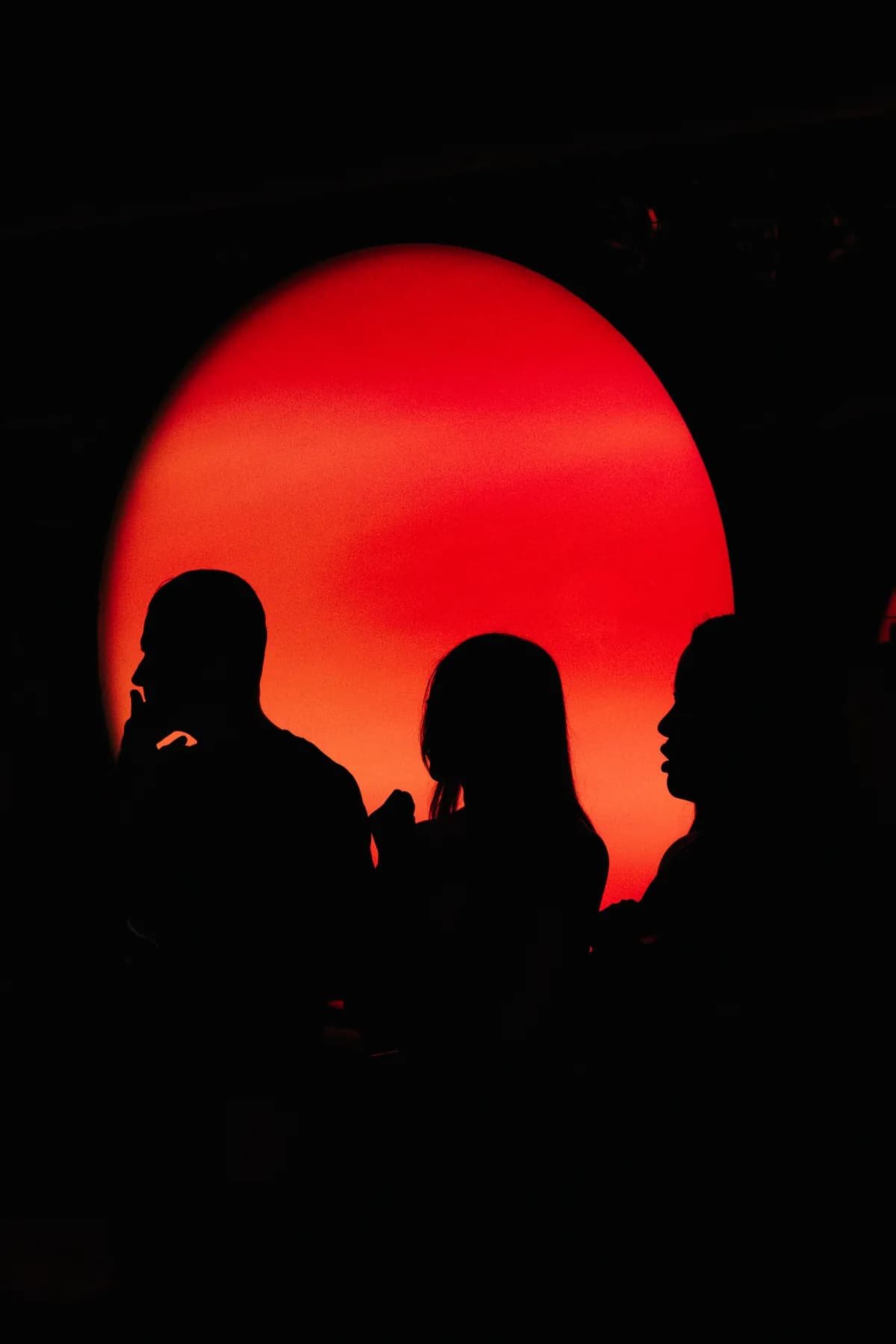 Guests silhouetted against MIRA's red light